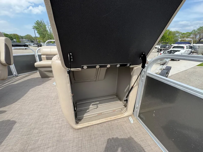 Slide: The Image of 2021 Sun Tracker Party Barge 20 DLX storage compartment open on deck. - 18