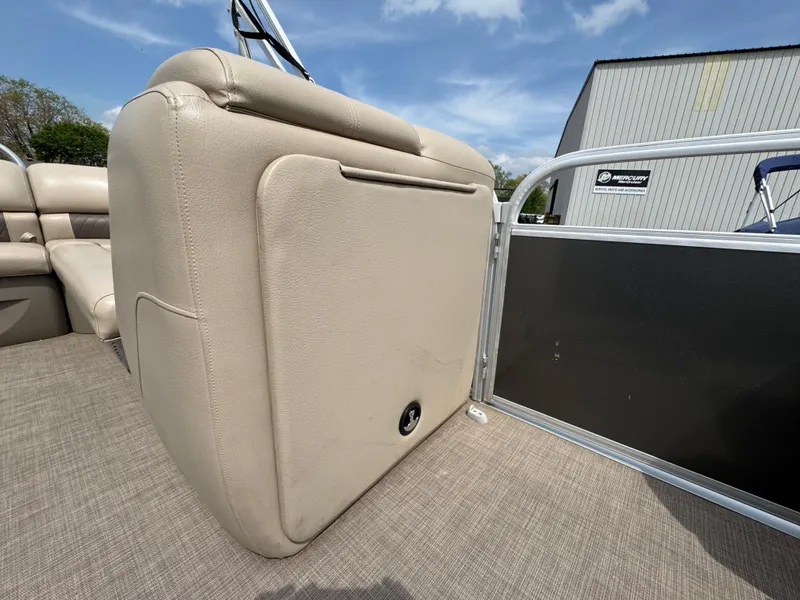 Slide: The Image of 2021 Sun Tracker Party Barge 20 DLX interior with beige seating and carpeted floor. - 7