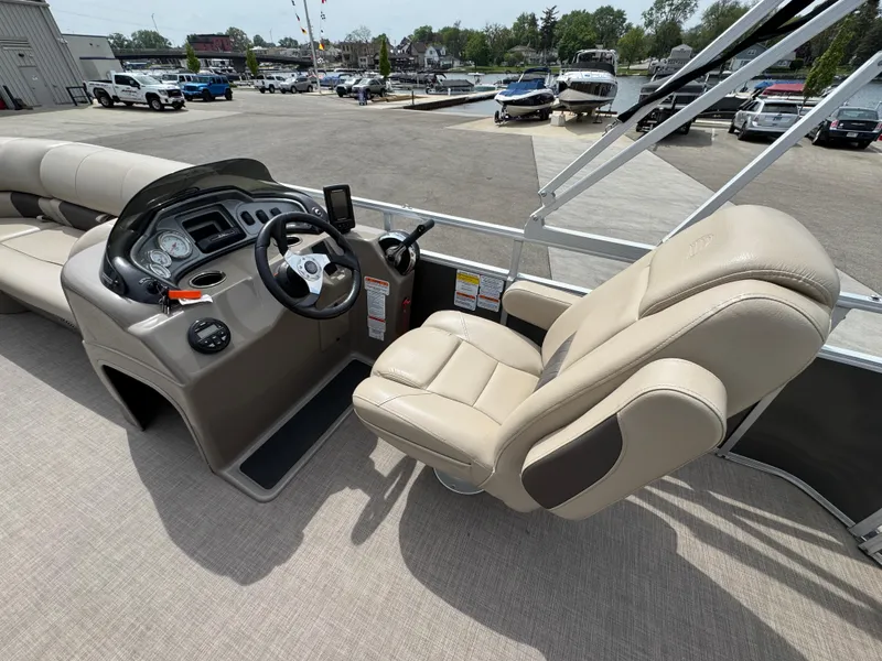 Slide: The Image of 2021 Sun Tracker Party Barge 20 DLX pontoon boat interior with captain's chair and control panel. - 8