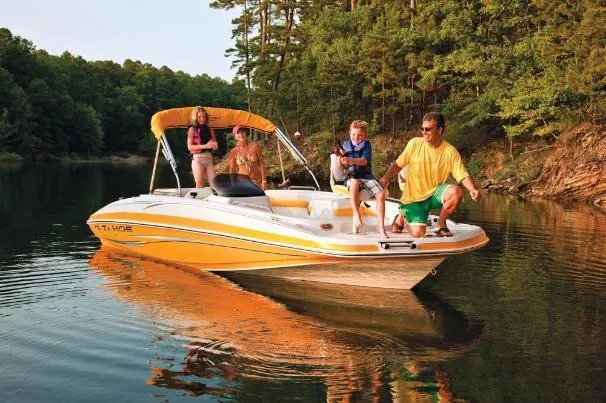 Slide: The Image of Family enjoying a day on a 2012 Tahoe 195 boat in a scenic lake. - 2