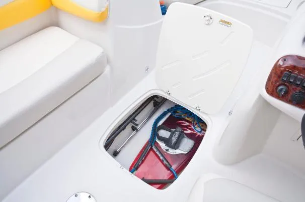 Slide: The Image of 2012 Tahoe 195 boat storage compartment with open hatch, showing ropes and equipment. - 23