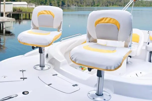 Slide: The Image of Two cushioned seats on a 2012 Tahoe 195 boat, overlooking a serene lake. - 24