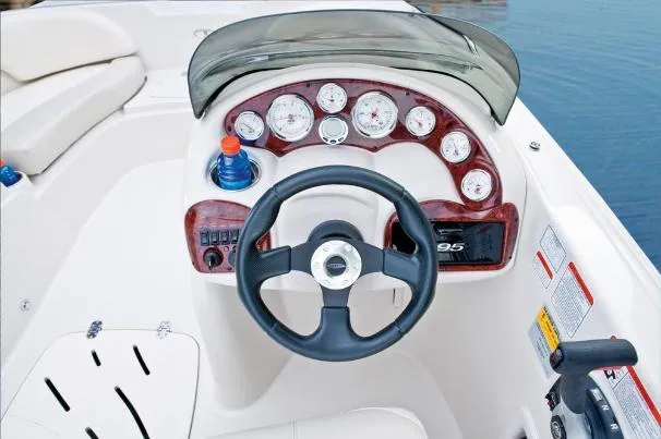Slide: The Image of Steering console of a 2012 Tahoe 195 boat with gauges and controls. - 25