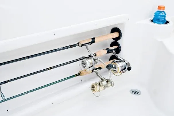 Slide: The Image of Fishing rods stored in a 2012 Tahoe 195 boat compartment with a drink holder. - 28
