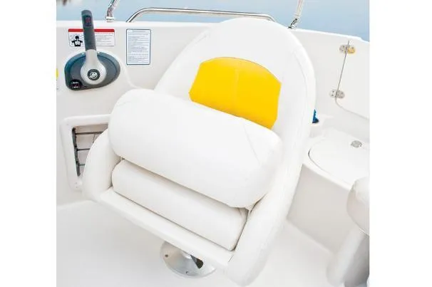 Slide: The Image of Captain's chair on 2012 Tahoe 195 boat, featuring white and yellow cushioned design. - 36