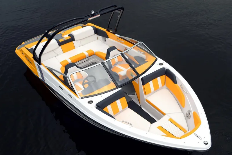 Slide: The Image of 2016 Glastron GTS 207 boat with vibrant orange and white interior on calm water. - 4