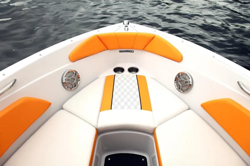 Slide: The Image of 2016 Glastron GTS 207 boat interior with orange and white seating, on water. - 6