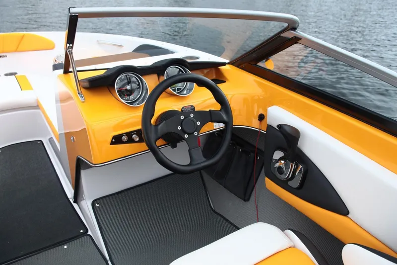 Slide: The Image of 2016 Glastron GTS 207 boat interior with yellow dashboard and steering wheel. - 8