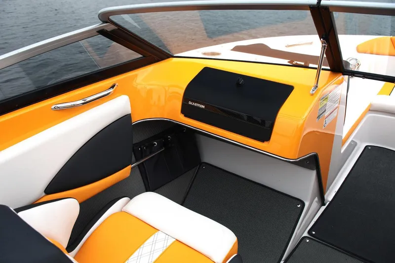 Slide: The Image of 2016 Glastron GTS 207 boat interior with orange and white seating, black accents. - 9