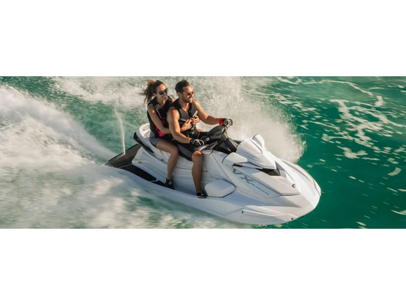 Slide: The Image of 2025 Yamaha VX Cruiser jet ski with two riders speeding on turquoise water. - 8