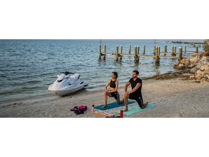 Slide: The Image of Couple doing yoga on beach near 2025 Yamaha VX Cruiser jet ski. - 9