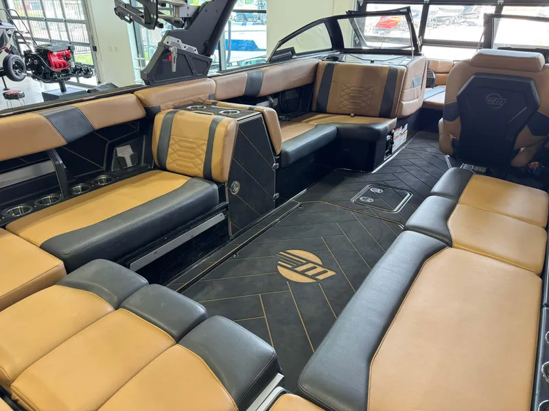 Slide: The Image of 2023 Malibu Wakesetter 26 LSV interior with luxurious tan and black seating. - 12