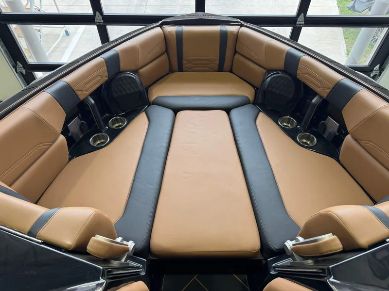Slide: The Image of Luxurious interior of 2023 Malibu Wakesetter 26 LSV boat with tan and black seating. - 13