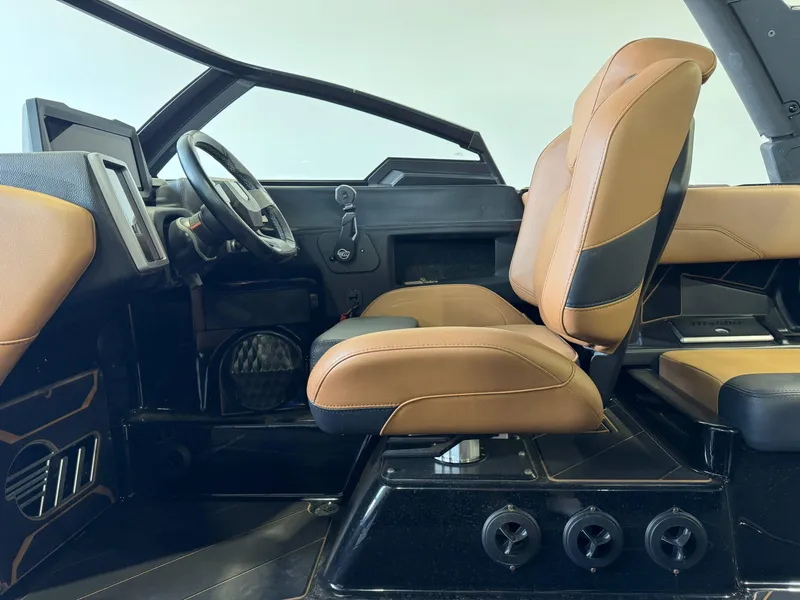Slide: The Image of 2023 Malibu Wakesetter 26 LSV interior with tan leather seats and modern dashboard. - 14