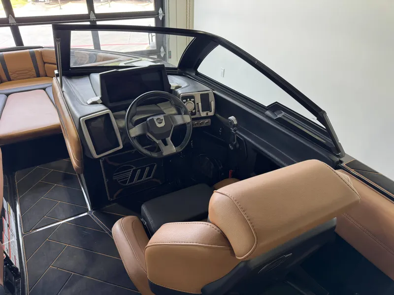 Slide: The Image of 2023 Malibu Wakesetter 26 LSV interior with modern dashboard and tan seating. - 16