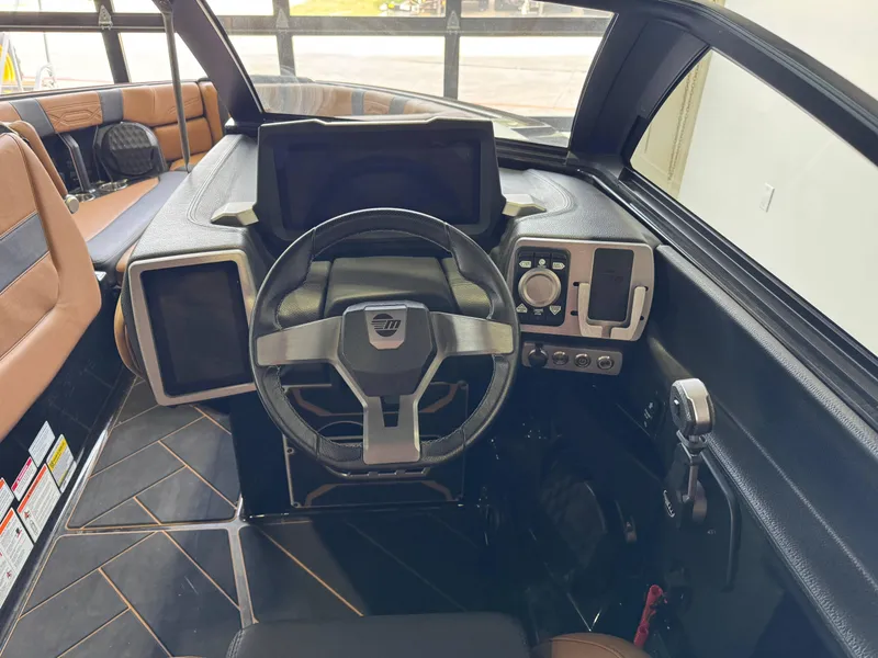 Slide: The Image of 2023 Malibu Wakesetter 26 LSV dashboard with steering wheel and control panel. - 17