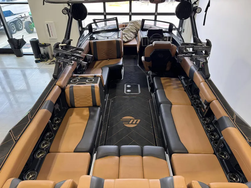 Slide: The Image of 2023 Malibu Wakesetter 26 LSV interior with luxurious tan and black seating. - 7