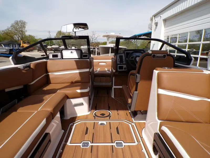 Slide: The Image of 2023 Supra SL 450 boat interior with brown leather seats and sleek design. - 10