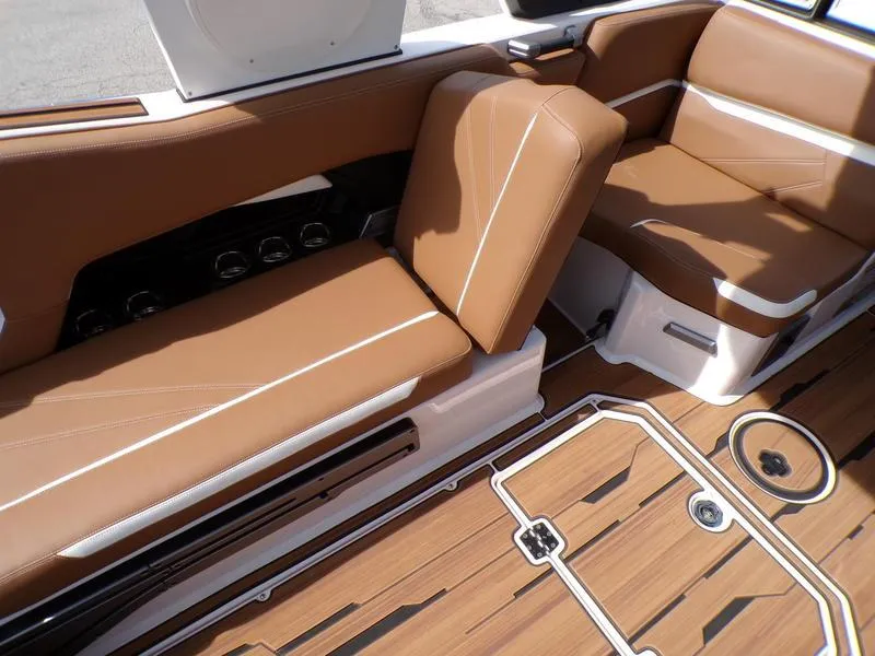 Slide: The Image of 2023 Supra SL 450 boat interior with brown leather seats and teak flooring. - 15
