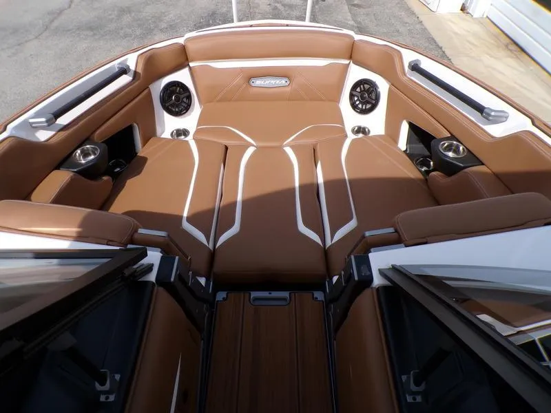 Slide: The Image of 2023 Supra SL 450 boat interior with brown leather seating and built-in speakers. - 18