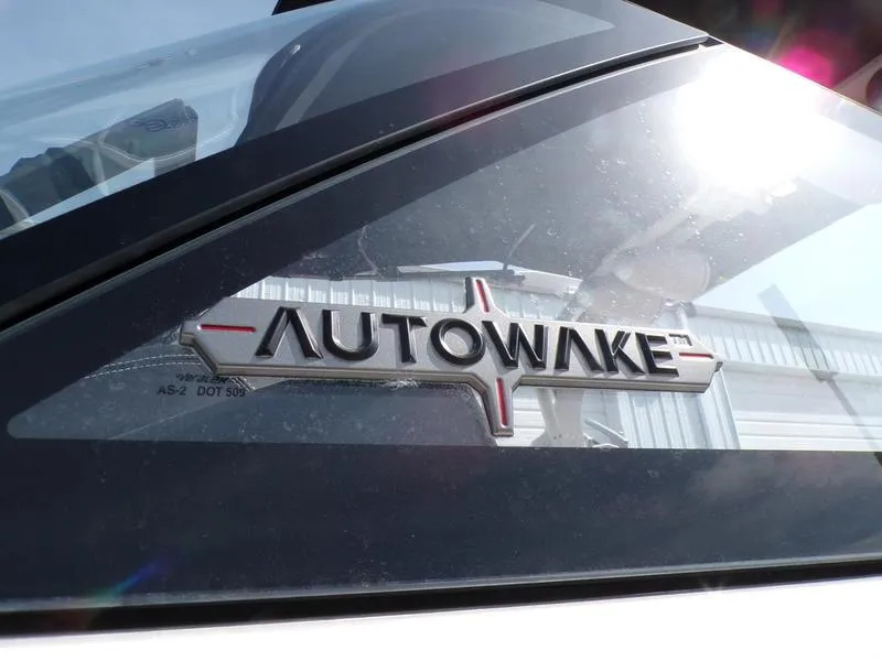 Slide: The Image of 2023 Supra SL 450 Autowake logo on boat window, reflecting sunlight. - 20