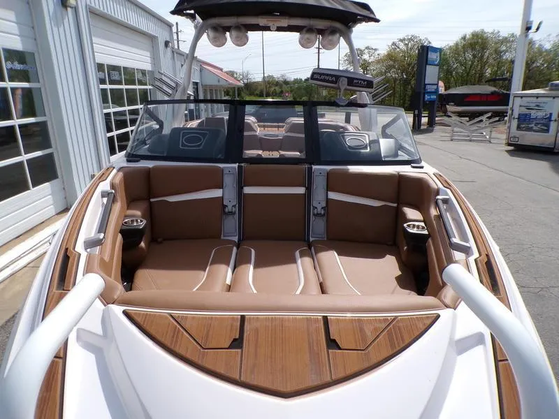 Slide: The Image of 2023 Supra SL 450 boat interior with brown seating and sleek design. - 21