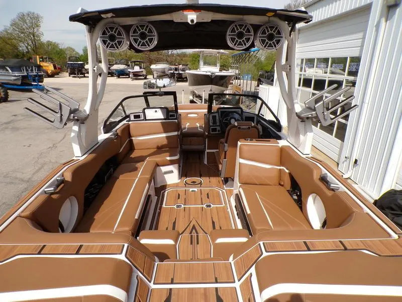 Slide: The Image of 2023 Supra SL 450 boat interior with brown seating and advanced audio system. - 6