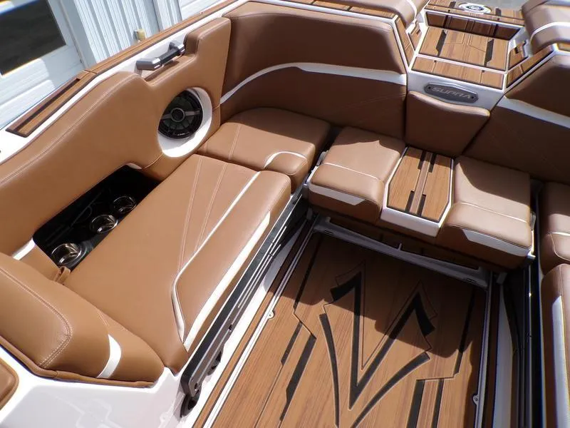 Slide: The Image of 2023 Supra SL 450 boat interior with brown leather seats and stylish wood flooring. - 8