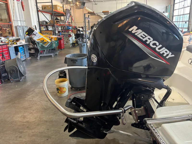 Slide: The Image of 2020 Tracker TAHOE T16 with Mercury outboard motor in a workshop setting. - 4