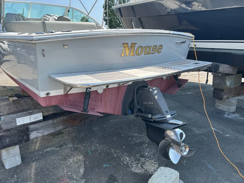 Slide: The Image of 2016 Hunt Yachts Harrier 25, named "Mouse," on dry dock with visible propeller. - 2