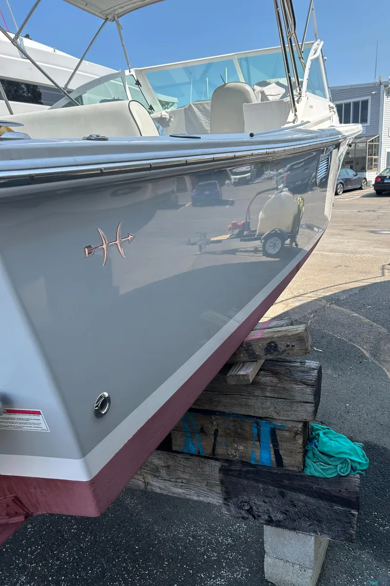 Slide: The Image of 2016 Hunt Yachts Harrier 25 boat on display, side view with sleek design. - 3