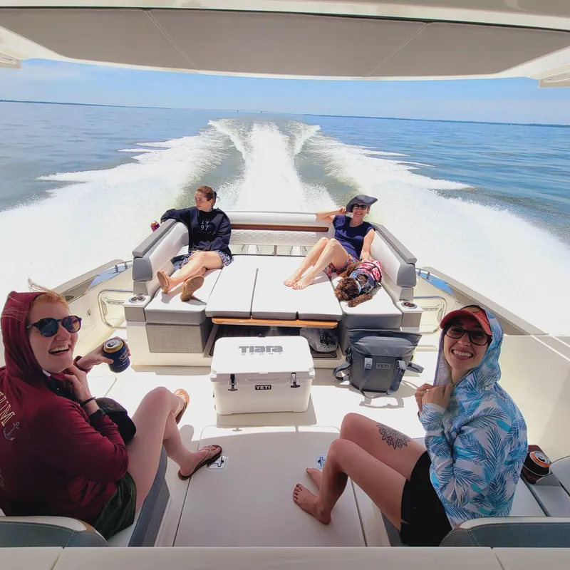 Slide: The Image of People relaxing on a 2021 Tiara Yachts 38 LS, enjoying a sunny day at sea. - 14