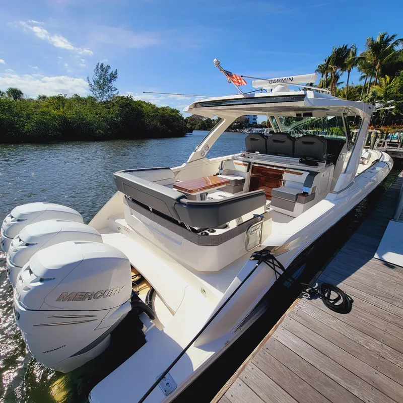 Slide: The Image of 2021 Tiara Yachts 38 LS docked, featuring triple Mercury engines and luxurious seating. - 17