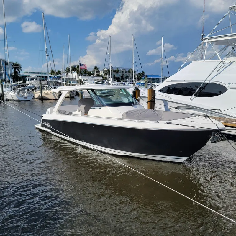 Slide: The Image of 2021 Tiara Yachts 38 LS docked at marina under blue sky. - 18
