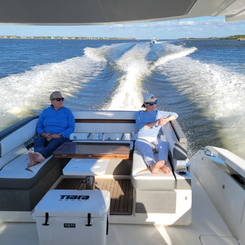 Slide: The Image of 2021 Tiara Yachts 38 LS cruising with passengers, leaving a wake on a sunny day. - 25