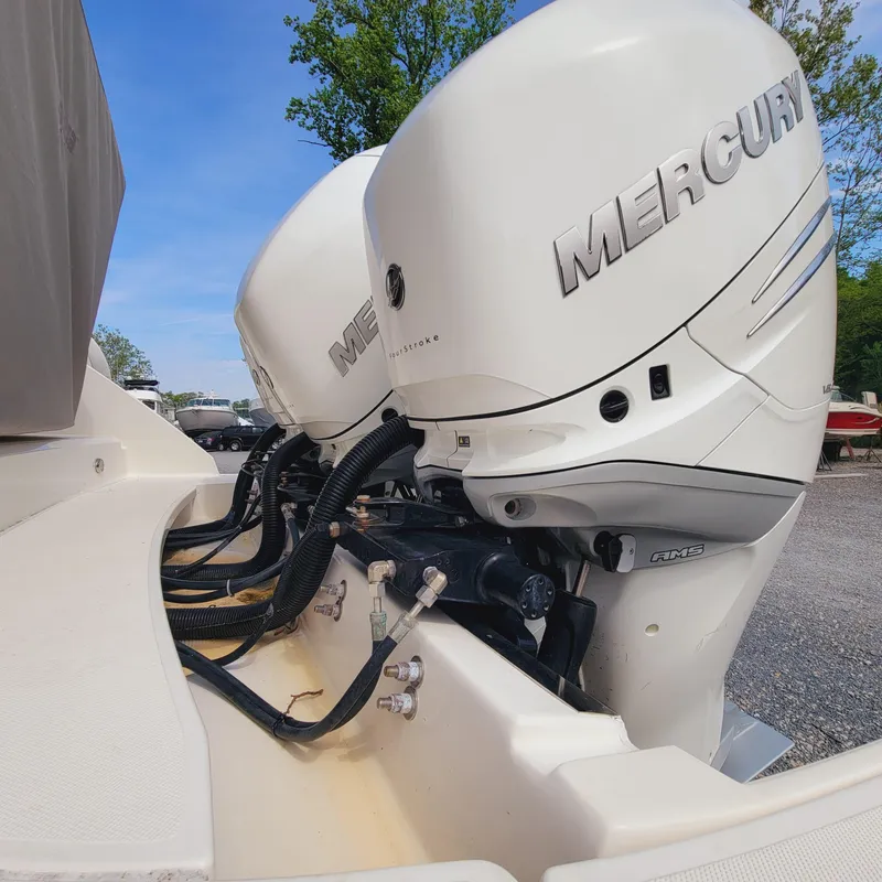 Slide: The Image of Twin Mercury outboard engines on a 2021 Tiara Yachts 38 LS, parked outdoors. - 30