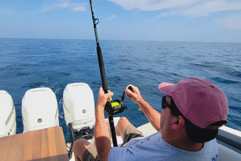Slide: The Image of Man fishing on a 2021 Tiara Yachts 38 LS in open sea. - 33