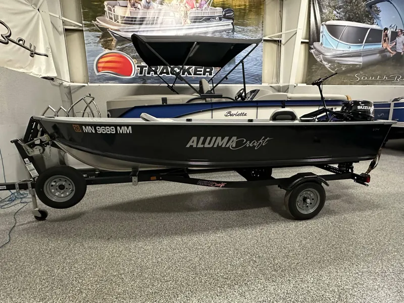 Slide: The Image of 2023 Alumacraft V14 boat on trailer in showroom, side view. - 1