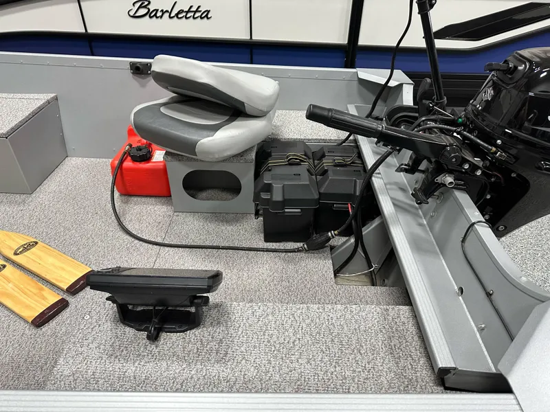 Slide: The Image of 2023 Alumacraft V14 boat interior with motor, seat, and paddles. - 11