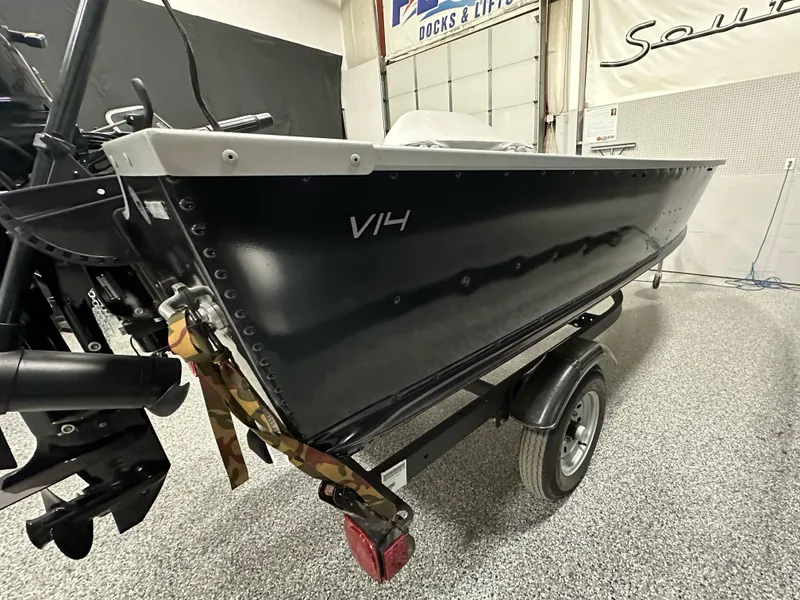 Slide: The Image of 2023 Alumacraft V14 boat on trailer in showroom. - 16