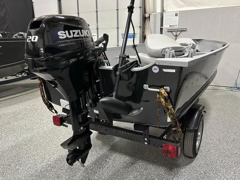 Slide: The Image of 2023 Alumacraft V14 boat with Suzuki 20 horsepower outboard motor in a showroom. - 3
