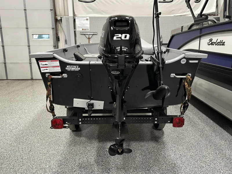 Slide: The Image of 2023 Alumacraft V14 boat with 20HP motor in a garage setting. - 4