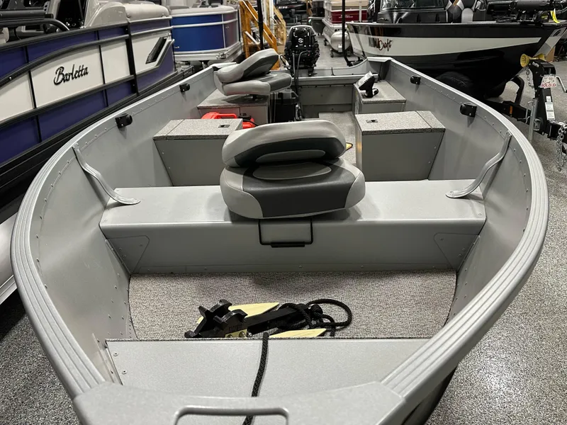 Slide: The Image of 2023 Alumacraft V14 boat interior with seating and storage compartments. - 7