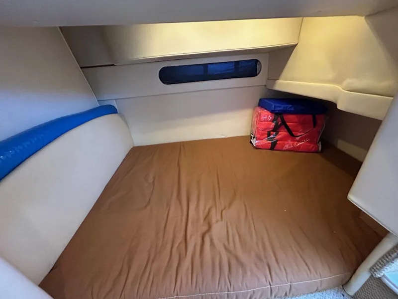 Slide: The Image of 2007 Bayliner 305 cabin interior with bed and storage area. - 17