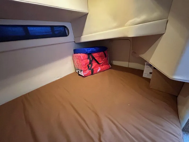 Slide: The Image of 2007 Bayliner 305 cabin interior with storage and red bag. - 18