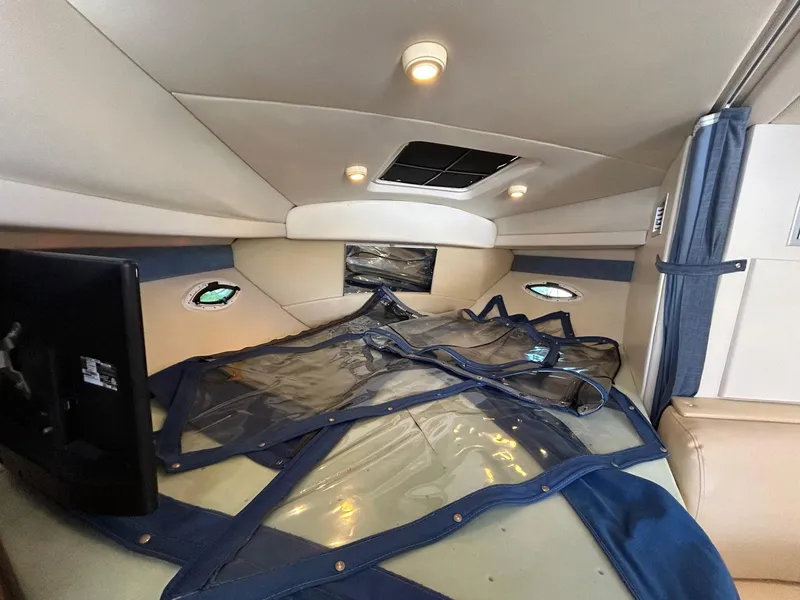 Slide: The Image of 2007 Bayliner 305 cabin interior with TV and portholes. - 25