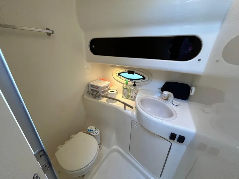 Slide: The Image of 2007 Bayliner 305 boat bathroom with toilet, sink, and storage. - 28