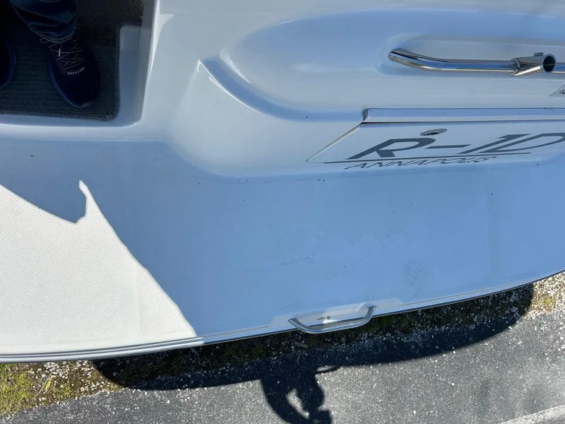 Slide: The Image of 2007 Bayliner 305 boat deck with white surface and metal handle. - 7