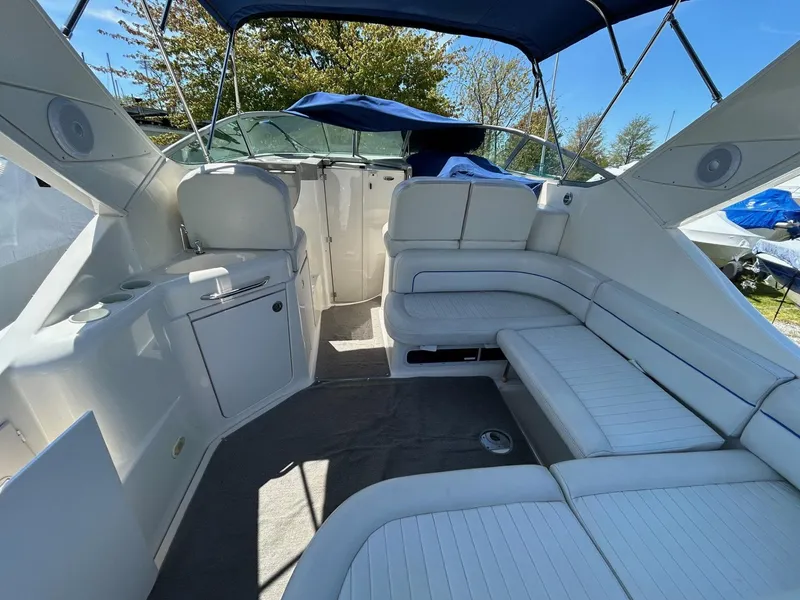 Slide: The Image of 2007 Bayliner 305 boat interior with white seating and canopy. - 8