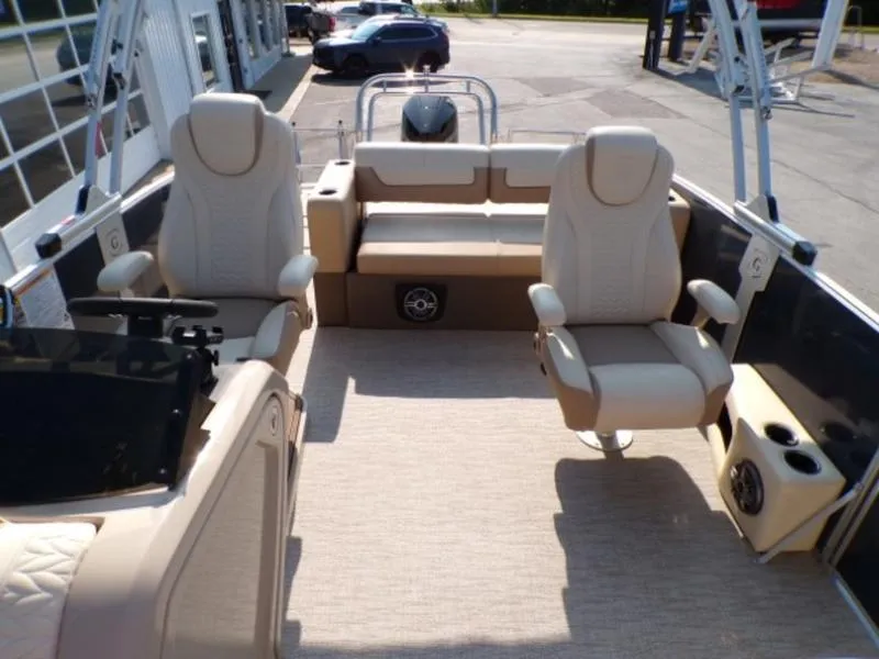 Slide: The Image of 2025 Godfrey Monaco 255 DFL boat interior with beige seating and modern design. - 11